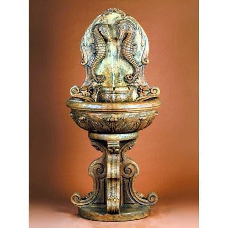 Outdoor wall fountain with a seahorse design.