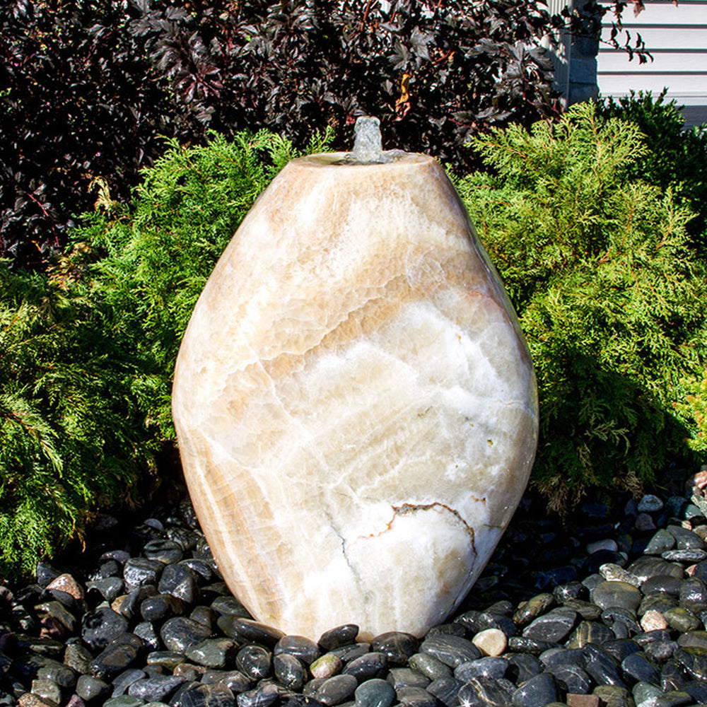 Yellow onyx stone fountain shaped like an almond