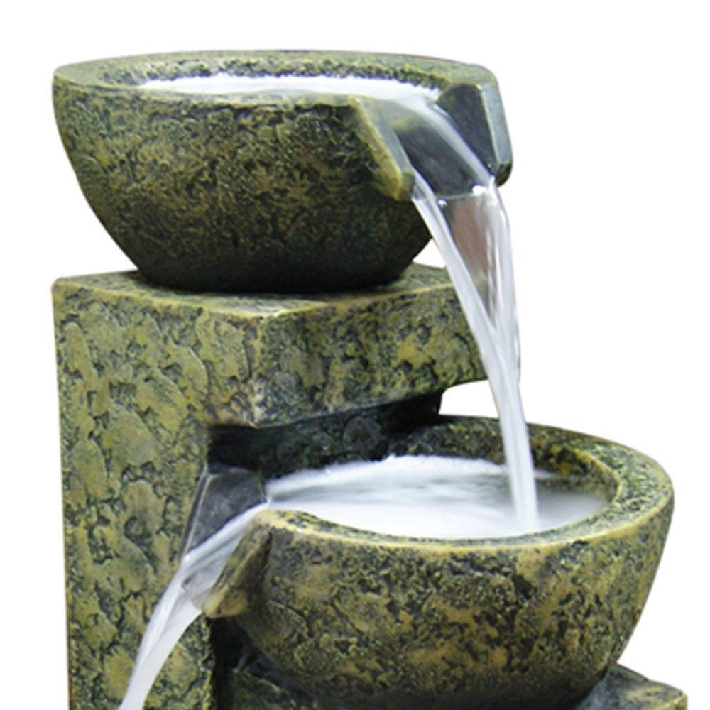 Three-tier stone bowl water fountain with cascading water.