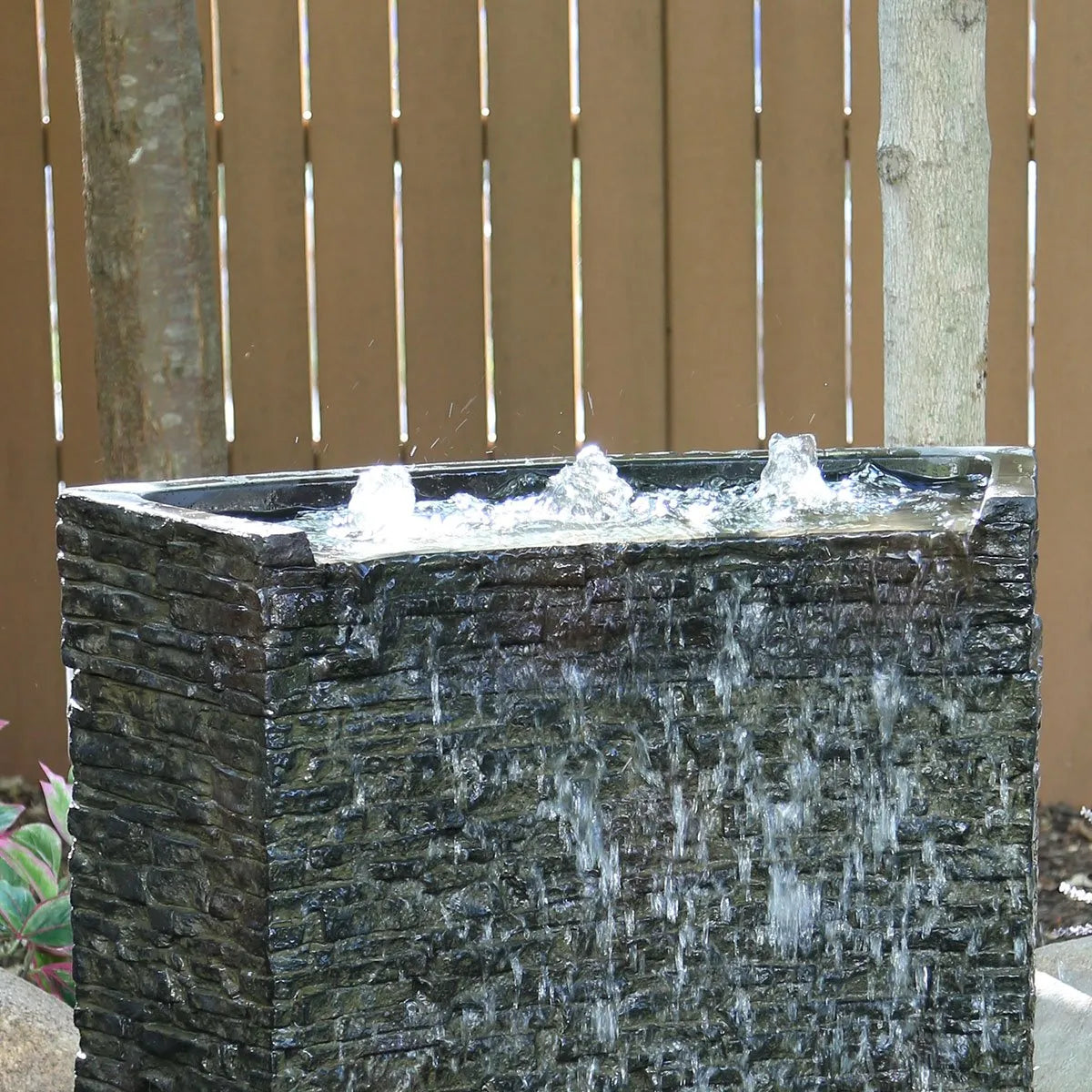 Stacked slate wall topper with curved front spill.