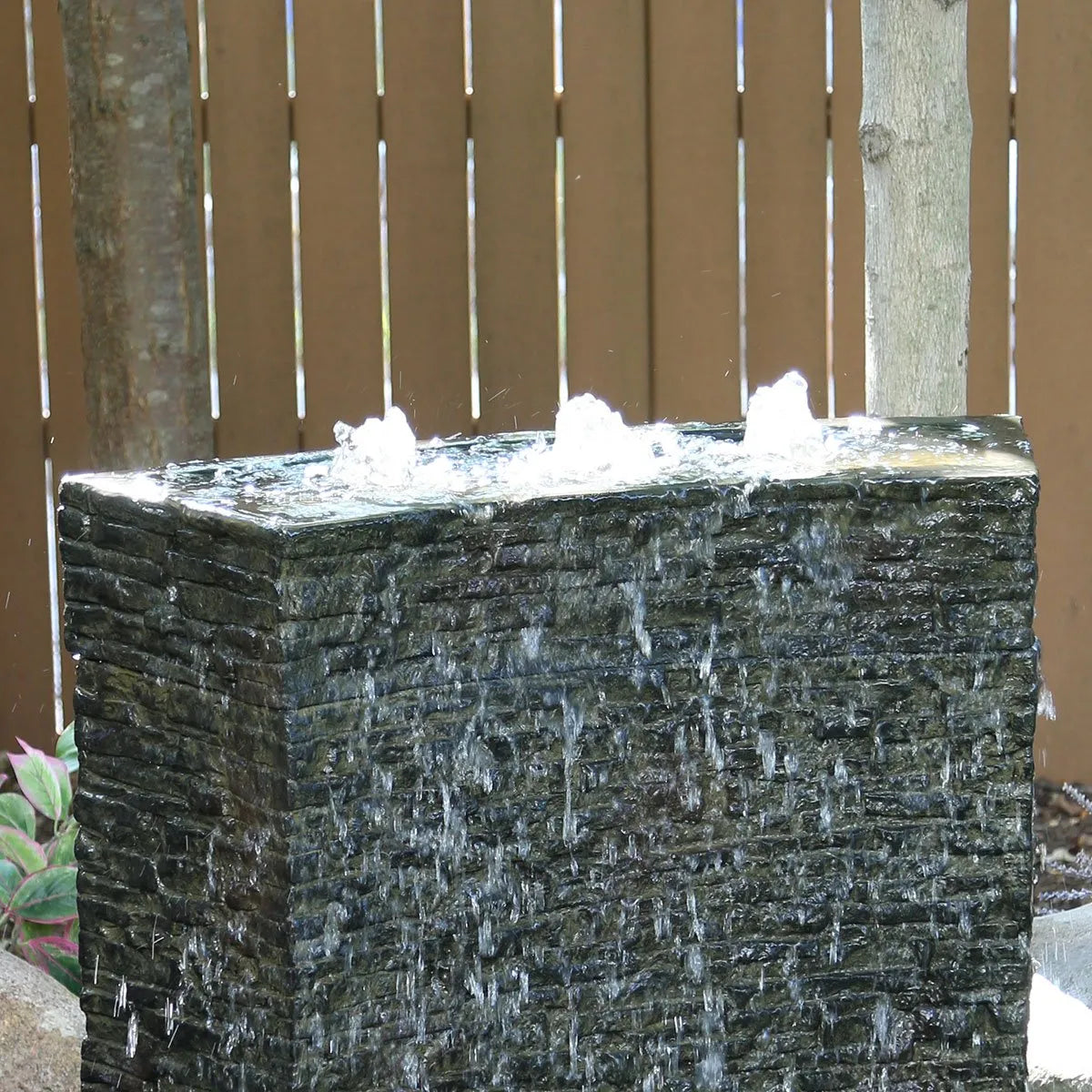 Stacked slate wall topper with curved quad-spill water feature
