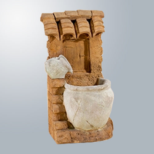 A small, decorative tabletop fountain with a tiered design and a light at the bottom.