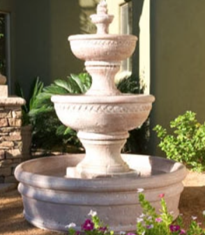 Concrete three-tiered garden fountain with basin.