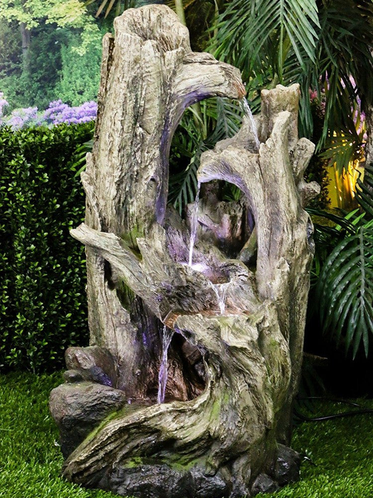 Large tree trunk fountain with LED lights.