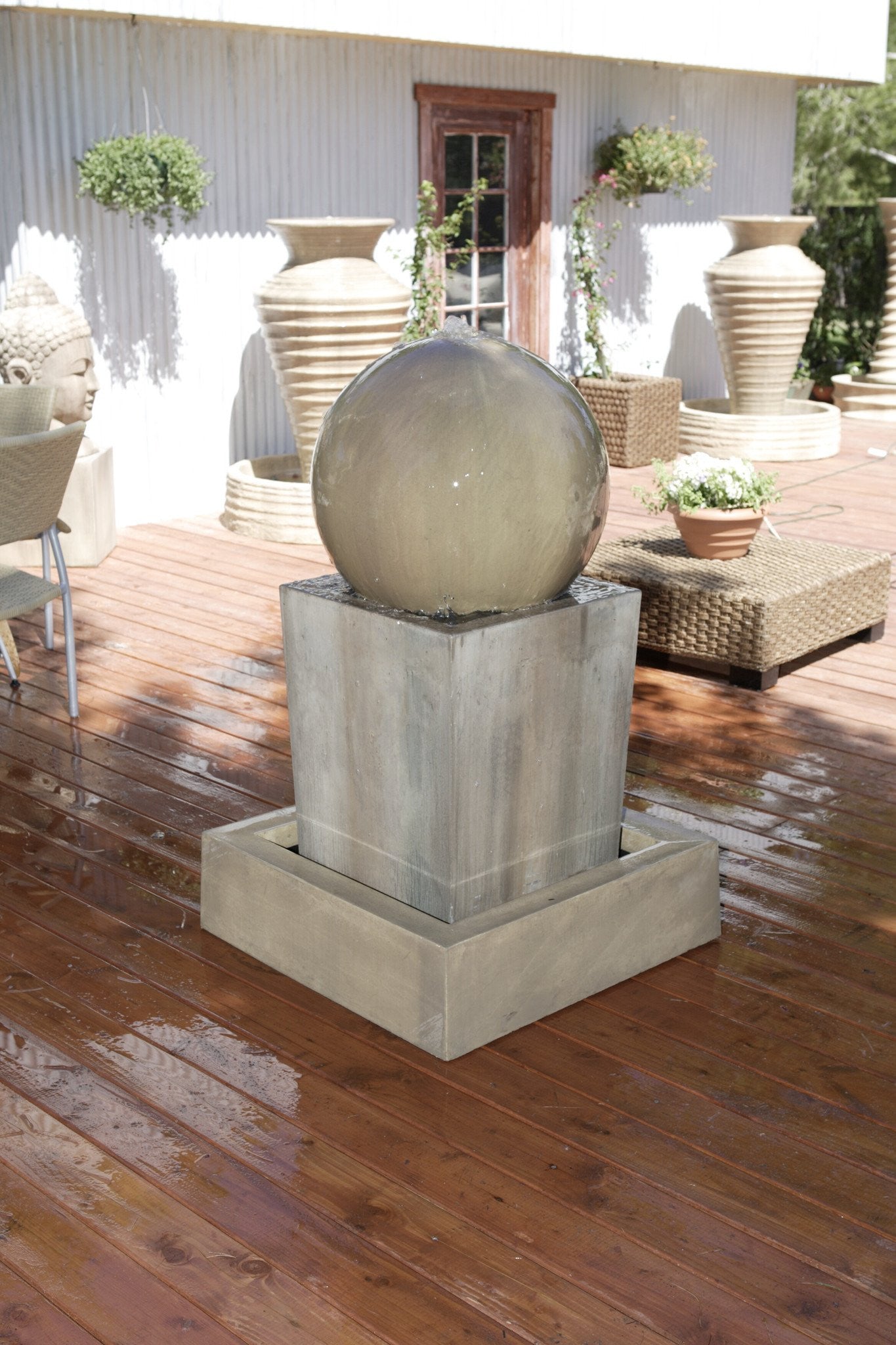 Garden fountain with a large, round ball feature.