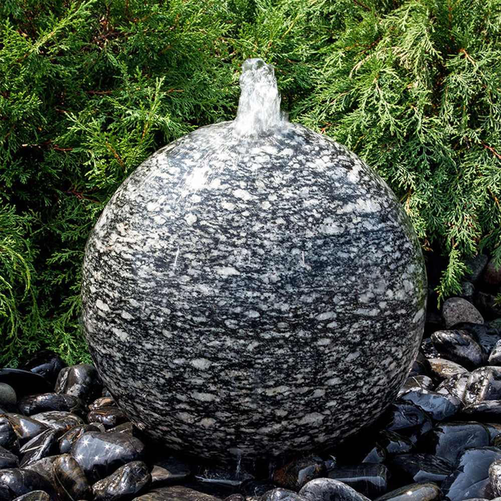 Speckled granite sphere stone fountain with water flowing