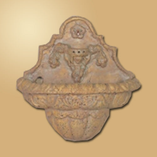 Travertine wall fountain with an angel sculpture.