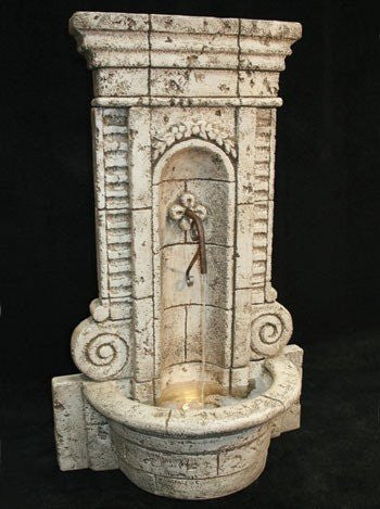 Outdoor fountain with multiple tiers and water cascading down, resembling champagne bubbles.